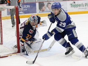 Darian Pilon, right, of the Sudbury Wolves, looks for a rebound as goalie Leo Lazarev, of the Barrie Colts, looks on during OHL action at the Sudbury Community Arena in Sudbury, Ont. on Friday January 26, 2018. John Lappa/Sudbury Star/Postmedia Network