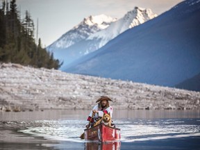 Endurance paddler Mike Ranta, in his trademark birchbark hat, paddles through the Rocky Mountains last year along with canine companion Spitzii. He now calls Killarney his home base. (David Jackson/For The Sudbury Star)