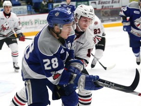 Drake Pilon, left, of the Sudbury Wolves, and William Lochead, of the Niagara IceDogs, battle for position during OHL action at the Sudbury Community Arena in Sudbury, Ont. on Saturday January 27, 2018. John Lappa/Sudbury Star/Postmedia Network