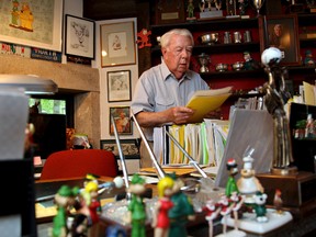 In this Aug. 16, 2010 file photo, Mort Walker, the artist and author of the Beetle Bailey comic strip, looks over notes and documents in his studio in Stamford, Conn. (AP Photo/Craig Ruttle)