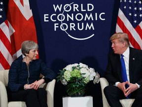 US President Donald Trump meeting with British Prime Minister Theresa May at the World Economic Forum in Davos, Switzerland. President Donald Trump has wished Prince Harry and fiancee Meghan Markle well and says he is not aware of having received an invitation to their royal wedding in May. (AP Photo)