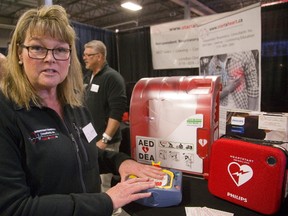 Respiratory therapist Julia Fazakas-Lewis tells Lifestyle Home Show visitors that defibrillators are an affordable lifesaver for home, work or cottage. (MIKE HENSEN, The London Free Press)
