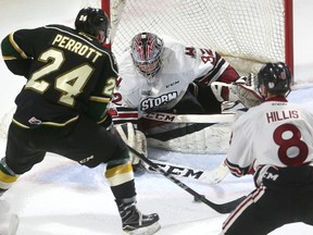 Guelph Storm goaltender Anthony Popovich makes a save on Andrew Perrott of the London Knights as the Storm?s Cam Hillis defends  in Ontario Hockey League action Sunday at Budweiser Gardens.   Guelph won 3-2. (Mike Hensen/The London Free Press)