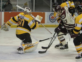 Kingston Frontenacs goaltender Jeremy Helvig gives out a rebound and the Peterborough Petes pounce during the first period of Ontario Hockey League action at the Rogers K-Rock Centre on Sunday. Helvig made 28 saves as the Fronts blanked Peterborough, 2-0. (Steph Crosier/The Whig-Standard/Postmedia Network)
