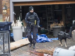 A police officer and dog outside a Toronto home linked to the murder investigation focused on Bruce McArthur.