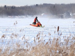 A snowmobiler makes their way across Whitewater Lake near Sudbury earlier this winter. (Gino Donato/Postmedia file photo)