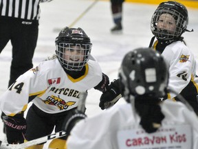 Ava Harmer (left) of the Mitchell Novice girls is all smiles as she celebrates her goal with teammates Avery Smith (right) and others this past Saturday, Jan. 27. Alas, it was the only goal of the game in a 2-1 loss. ANDY BADER/MITCHELL ADVOCATE