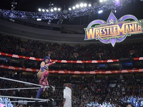 Asuka points to the WrestleMania 34 sign following her win in the inaugural women's Royal Rumble in Philadelphia on Sunday. (World Wrestling Entertainment)