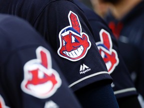 In this June 19, 2017 file photo, members of the Cleveland Indians wear uniforms featuring mascot Chief Wahoo as they stand on the field for the national anthem before a baseball game against the Baltimore Orioles in Baltimore. (AP Photo)