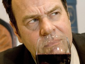 Dan Aykroyd holds up a glass of one of his new Ontario wines.