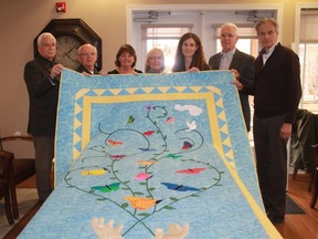 Business owner Rob Bedard presented St. Joseph's Hospice with a quilt that was used during farewell ceremonies. From left: St. Joseph's Hospice Executive Director Larry Lafranier, Rob Bedard, Darlene Bedard, Cathy Cloutier, Dr. Allison Crombeen, Jack Stewart and Dr. Glen Madison.
CARL HNATYSHYN/SARNIA THIS WEEK