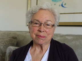 Aamjiwnaang elder Geraldine Robertson is shown in this file photo holding a photo of herself as a child when she was taken to live in residential schools. Robertson has been named to the Order of Ontario for her work helping fellow residential school survivors and raising awareness of the issue. (File photo/Sarnia Observer/Postmedia Network)