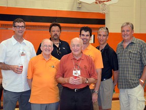 Len Thompson (front row, orange shirt) poses for a photo at a Lasalle Secondary School reunion in 2012. Thompson, who passed away last week, remained dedicated to coaching basketball and to the school's alumni association long after his retirement. Photo supplied