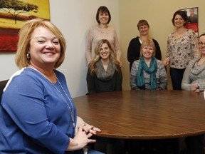 Luke Hendry/The Intelligencer
United Way Hastings and Prince Edward executive director Kathy Murphy, left, sits with her team Friday, May 12, 2017 in the office Belleville. Seated behind her are, from left, Kirsten Wight, Cindi Nicholls (on loan from Canada Revenue Agency) and Jodi Cooper. Standing are Paula Nopper, left, Tambra Patrick-MacDonald and Melanie Cressman. Not pictured: Brandi Hodge.