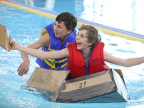 BRUCE BELL/THE INTELLIGENCER
Grant Gailbraith (left) and Samuel Evans of Sacred Heart Catholic School in Batawa appear to be overjoyed their vessel floated during the Skills Ontario Cardboard Boat Races on Wednesday. More than 100 Grade 7 and 8 students from the Quinte and Kawartha regions gathered at the Quinte Sports and Wellness Centre for the one-day event.