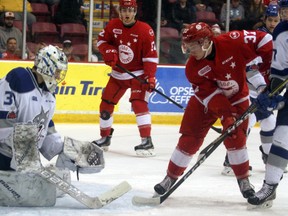 Sudbury Wolves goalie Jake McGrath eyes the puck as Soo Greyhounds Jack Kopacka and Ryan Roth watch during first-period Ontario Hockey League action at Essar Centre in Sault Ste. Marie, Ont., on Wednesday, Jan. 31, 2018. (BRIAN KELLY/THE SAULT STAR/POSTMEDIA NETWORK)