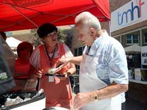 The late Phil Panelas mans the barbecue at a fundraiser for the Trenton Memorial Hospital Foundation. He died Thursday in Kingston.