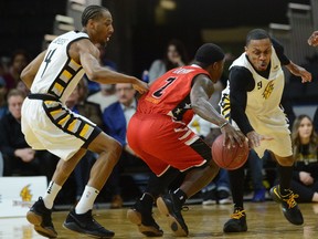 Lightning guard Doug Herring Jr. goes for the steal on Windsor Express guard Braylon Rayson during their National Basketball League of Canada game at Budweiser Gardens on Thursday night. The Express won 123-120. (MORRIS LAMONT, The London Free Press)