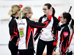 Ontario third Stephanie LeDrew, right, of Sarnia, Ont., gives a high-five to skip Hollie Duncan as they celebrate a win over Newfoundland and Labrador to secure a spot in the championship round at the Scotties Tournament of Hearts in Penticton, B.C., on Thursday, Feb. 1, 2018. (SEAN KILPATRICK/The Canadian Press)