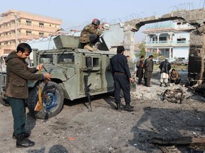 NOORULLAH SHIRZADA/Getty Images
Afghan security forces inspect the site of an attack by Islamic State militants at the British charity Save the Children compound in Jalalabad on Jan. 25. As Islamic State militants stormed Save the Children's compound in Afghanistan's east on Jan. 24, Kamran Khan and his terrified colleagues ran for their lives to the basement. For nearly 10 hours, dozens of men and women working for the British charity in Jalalabad city huddled in the “safe room,” listening to the fierce gunfight between the attackers and Afghan security forces just metres away.