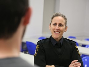 Jason Miller/The Intelligencer
Insp. Sherri Meeks talks with one of the attendees at Thursday's town hall meeting held at Parkdale Community Centre.