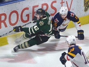 London Knights defenceman Jacob Golden is pulled down by Barrie forward Jaden Pecca as Colts teammate Zahary Magwood follows the play during the first period of their Ontario Hockey League game at Budweiser Gardens on Friday night. (MORRIS LAMONT, The London Free Press)
