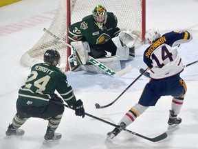 Barrie Colts forward Andrei Svechnikov gets the shot off at London Knights goaltender Joseph Raaymakers and defenceman Andrew Parrott during an Ontario Hockey League game at Budweiser Gardens on Friday, February 2, 2018. (MORRIS LAMONT, The London Free Press)