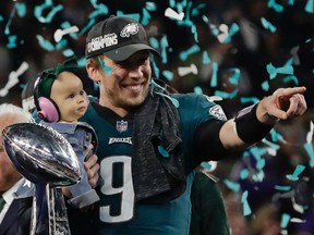 Philadelphia Eagles quarterback Nick Foles (9) holds his daughter, Lily James, after winning the NFL Super Bowl 52 football game against the New England Patriots, Sunday, Feb. 4, 2018, in Minneapolis. The Eagles won 41-33. (Frank Franklin II / AP)