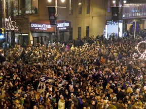 Fans celebrate near Broad and Locust streets in Philadelphia as the Philadelphia Eagles win the NFL Super Bowl 52 football game against the New England Patriots on Sunday, Feb. 4, 2018. The Eagles won 41-33. (Tom Gralish/The Philadelphia Inquirer via AP)