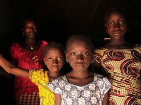 A woman and her daughters stand in their home, in the village of Cambadju in Guinea-Bissau, the first in the country to renounce female genital mutilation/cutting. CNW Group / UNICEF Canada