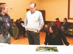 MDB Insight’s Harry Shnider speaks with James Phinney during the industrial land open house Jan. 25 at the Vulcan Lodge Hall. Also pictured is Carmen Pelletier, who’s looking at a map showing where a potential business park could be located. Jasmine O’Halloran Vulcan Advocate