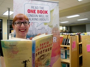 Linda Ludke, a collections management librarian with the London Public Library, peeks over a copy of Brother, by David Chariandy, the novel selected for this year’s One Book One London campaign. (CHRIS MONTANINI, Londoner)