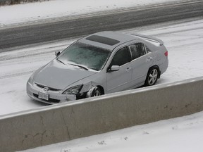 A vehicle rests against the centre median on the westbound 401 at Kingston in this file photo. Such concrete barriers are being sought for the London to Tilbury stretch of the highway. On Monday, the Ontario government said it would commit the installation of the concrete median, but suggested it could take as much as three years. File photo/Postmedia Network