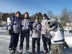 Sudbury Wolves players Doug Blaisdell, Zack Malik, Owen Gilhula and Shane Bulitka, along with team mascot Howler, pose for a photo at the Pond Hockey Festival on the Rock last weekend. Photo supplied
