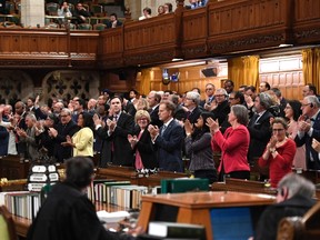 Liberal MPs rise for a standing ovation after Speaker of the House of Commons Geoff Regan stated that Bill C-210 had received royal assent, at the conclusion of Question Period in the House of Commons on Parliament Hill in Ottawa on Wednesday, Feb. 7, 2018. THE CANADIAN PRESS/Justin Tang
