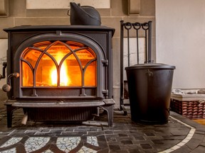 Cooking spray, Goo Gone or WD-40 will successfully remove the glue off the glass on your glass wood stove door. (Getty Images)