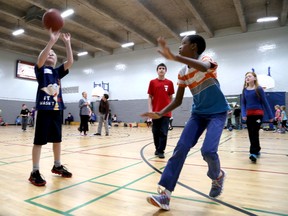 March Break Campers (from left) Brendan Brown, 10, and Kyle Kawadza play some basketball as referee Mason Christi looks on at YMCA of Kingston's Wright Crescent in 2014. Ian MacAlpine, The Whig-Standard, Postmedia Network