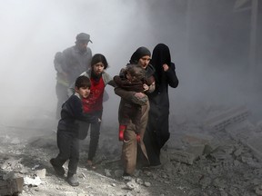 ABDULMONAM EASSA/Getty Images
Syrian civilians flee from reported regime air strikes in the rebel-held town of Jisreen, in the besieged Eastern Ghouta region on the outskirts of the capital Damascus, on Feb. 8. A fourth consecutive day of heavy regime bombing raids on the rebel-held enclave of Eastern Ghouta near Damascus killed 22 civilians on Feb. 8, a monitor said.