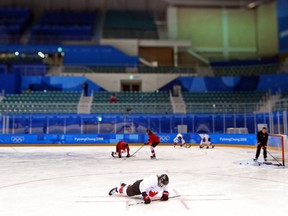 Canadian forward Bailey Bram does pushups during practice at the Pyeongchang Olympics on Feb. 8. (Jean Levac / Postmedia Network)