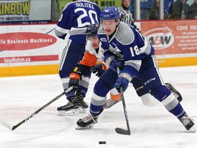 Macauley Carson, right, of the Sudbury Wolves, breaks to the net during OHL action against the Flint Firebirds at the Sudbury Community Arena in Sudbury, Ont. on Friday February 9, 2018. John Lappa/Sudbury Star/Postmedia Network