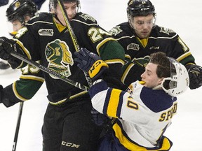 London Knights defenceman Andrew Perrott knocks Erie Otter forward Emmett Sproule for a loop during the first period of their OHL game at Budweiser Gardens in London on Friday night. (DEREK RUTTAN, The London Free Press)