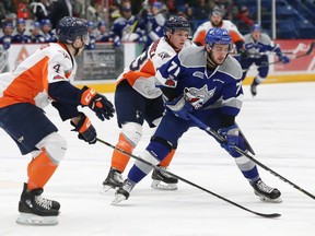 David Levin, right, of the Sudbury Wolves, attempts to elude Hakon Nilsen, left, and Ty Dellandrea, of the Flint Firebirds, during OHL action at the Sudbury Community Arena in Sudbury, Ont. on Friday February 9, 2018. John Lappa/Sudbury Star/Postmedia Network