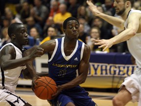 The Laurentian Voyageurs' David Aromolaran drives between a pair of Carleton Ravens during OUA men's basketball action in the Ben Avery Gym at Laurentian University on Saturday, February 10, 2018. Ben Leeson/The Sudbury Star/Postmedia Network