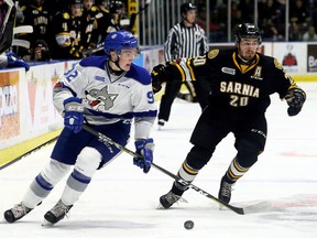 Sudbury Wolves' Blake Murray (92) is chased by Sarnia Sting's Connor Schlichting (20) in the second period at Progressive Auto Sales Arena in Sarnia, Ont., on Sunday, Feb. 11, 2018. (Mark Malone/Chatham Daily News/Postmedia Network)