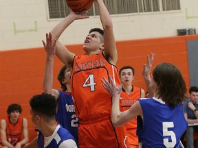 Noah Carpino, middle, of Lasalle Lancers, puts up a shot during senior boys high school basketball championship action against Sudbury Secondary School at Lasalle Secondary School in Sudbury, Ont. on Saturday February 18, 2017. John Lappa/Sudbury Star/Postmedia Network