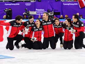 Canada's Scott Moir, left to right, Tessa Virtue, Gabrielle Daleman, Eric Radford, Meagan Duhamel, Kaetlyn Osmond, and Patrick Chan celebrate their gold medal victory in the team figure skating event at the Pyeonchang Winter Olympics Monday, February 12, 2018 in Gangneung, South Korea. THE CANADIAN PRESS/Paul Chiasson