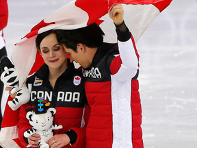 Tessa Virtue and Scott Moir celebrate Canada’s figure skating team event gold medal. Leah Hennel / Postmedia