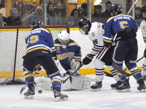 Jake Finlayson (26) of the Mitchell Hawks tries to stuff the puck past Wingham goaltender Wyatt Nicholson during action from Game 3 of their PJHL Pollock Division quarter-final series last Tuesday, Feb. 6. ANDY BADER/MITCHELL ADVOCATE