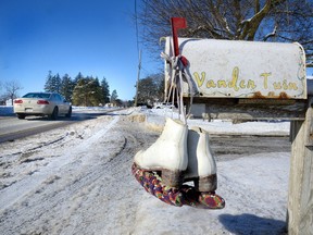A pair of white figure skates hang on a mailbox on Adelaide Street in Mt. Brydges on Monday in memory of 13-year-old Avery Kernaghan, inset, who was killed in a car crash Saturday. Many mailboxes in Mt. Brydges were adorned with skates because Kernaghan was a budding figure skater. Her father Douglas remains in critical condition. (MORRIS LAMONT, The London Free Press)
