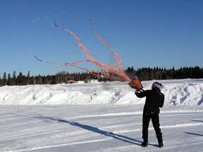 Quebec-based consultant and scientist Serge Couturier practices firing his net gun at the Wawa airport Monday morning in preparation for the translocation of Michipicoten Island caribou to Caribou Island.